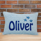 Blue chenille pillow with embroidered name and stars. Personalized gift idea