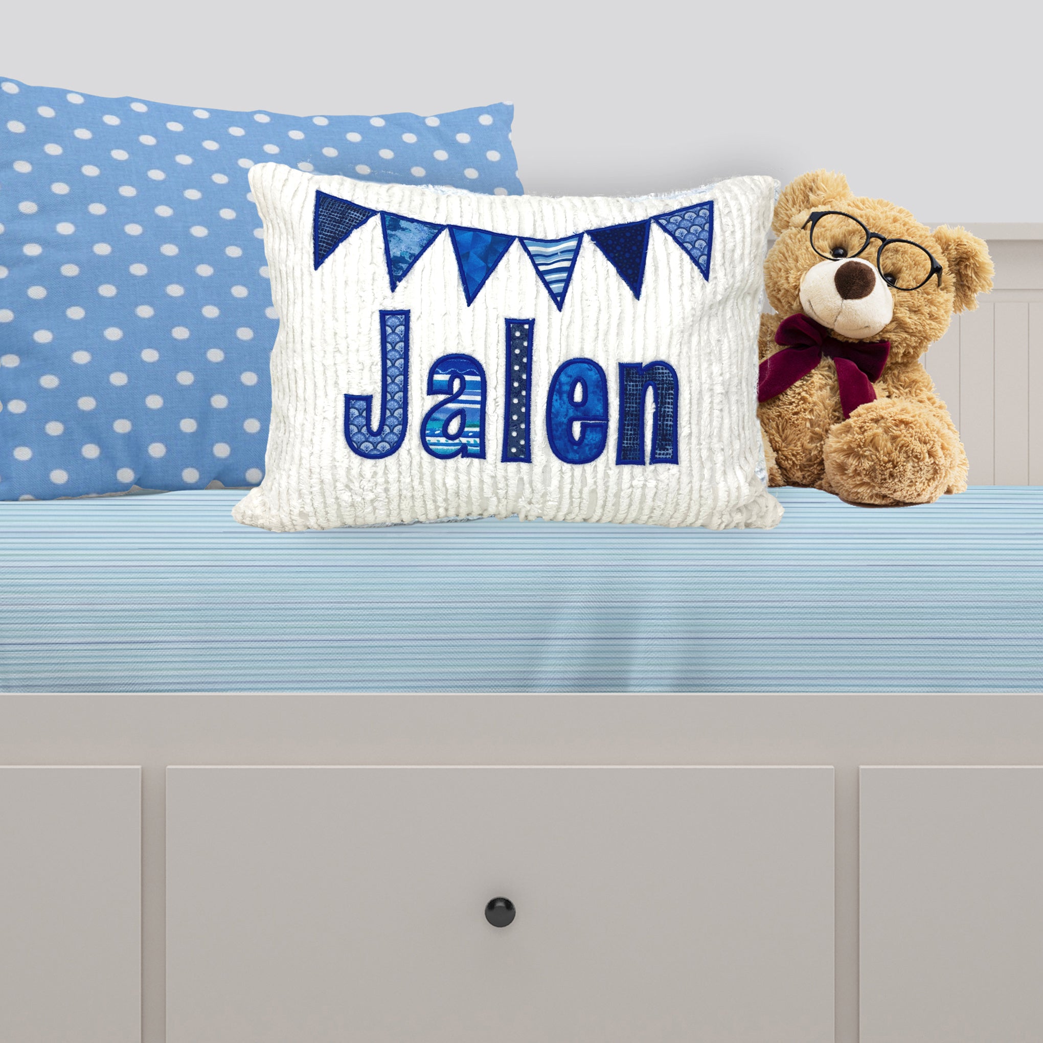 name pillow for boy- medium to dark blue applique name and flags
