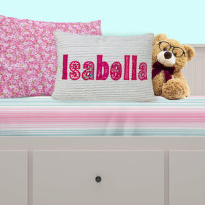 Personalized throw pillow for girls - white chenille fabric with bright pink applique name on bed