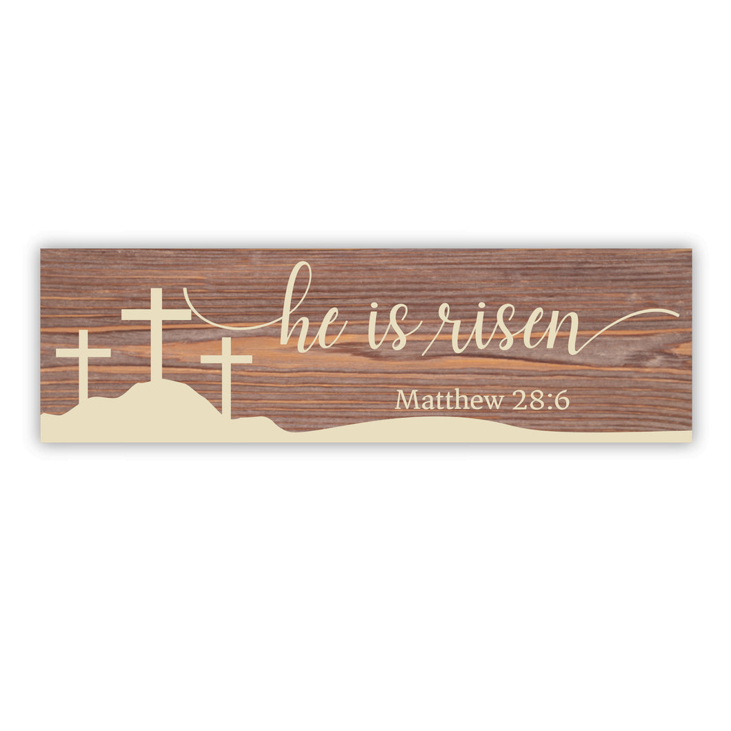 stained solid wood sign measures 7.25 by 23.5 inches. three crosses on a hill with He is risen text and Matthew 28:6. wood background with creamy painted design.